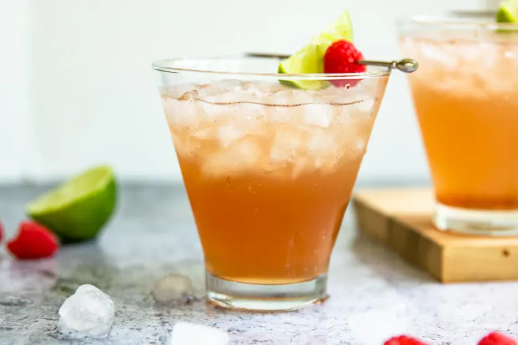 a margarita glass filled with a light pink chambord margarita