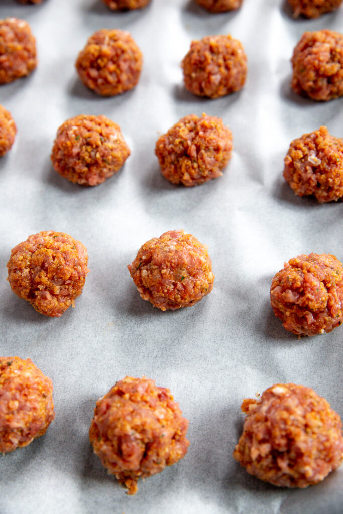 rolled turkey meatballs on parchment paper