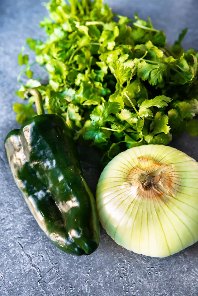 a poblano pepper, sweet onion, and a bunch of cilantro