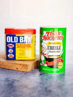 a container of old bay and tony chachere's creole seasoning