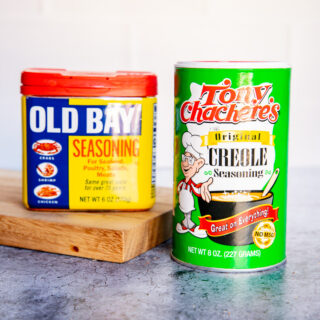 a container of old bay and tony chachere's creole seasoning