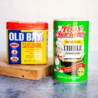 a container of old bay and tony chachere's creole seasoning