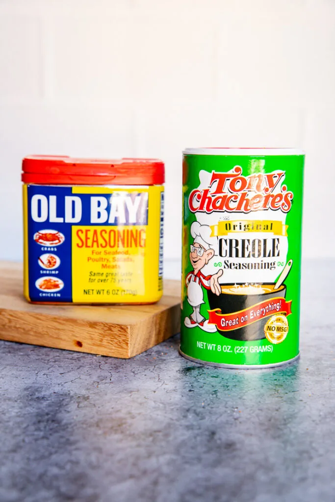 a container of old bay and tony chachere's creole seasoning