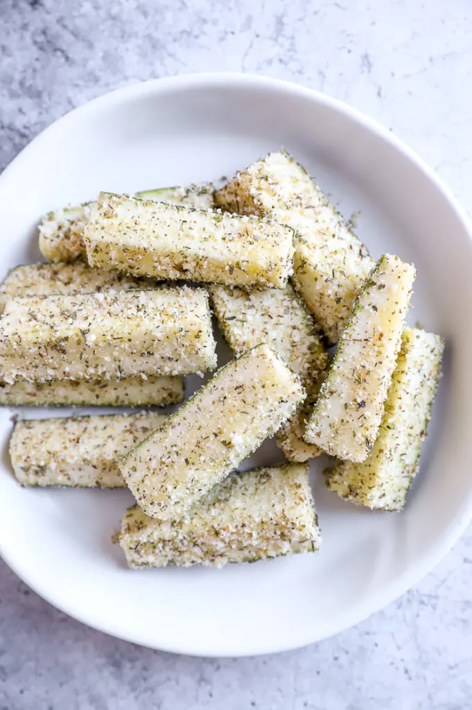 battered air fryer zucchini fries in a white bowl