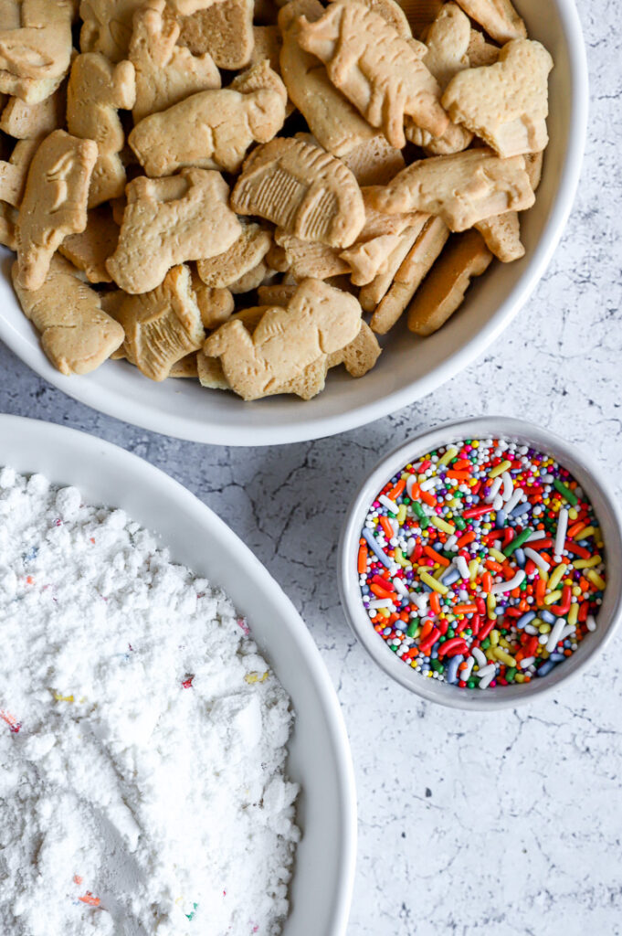 three bowls with animal crackers, sprinkles, and funfetti mix